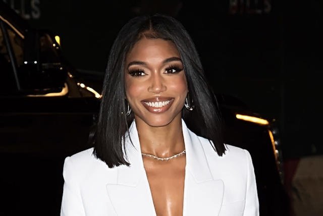 Lori Harvey in white pantsuit at Michael Kors Fashion Show for NYFW